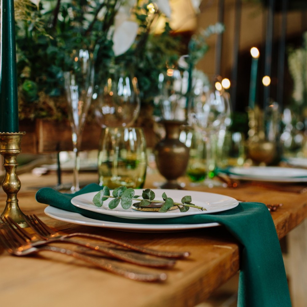 Winter wedding place setting with foliage.